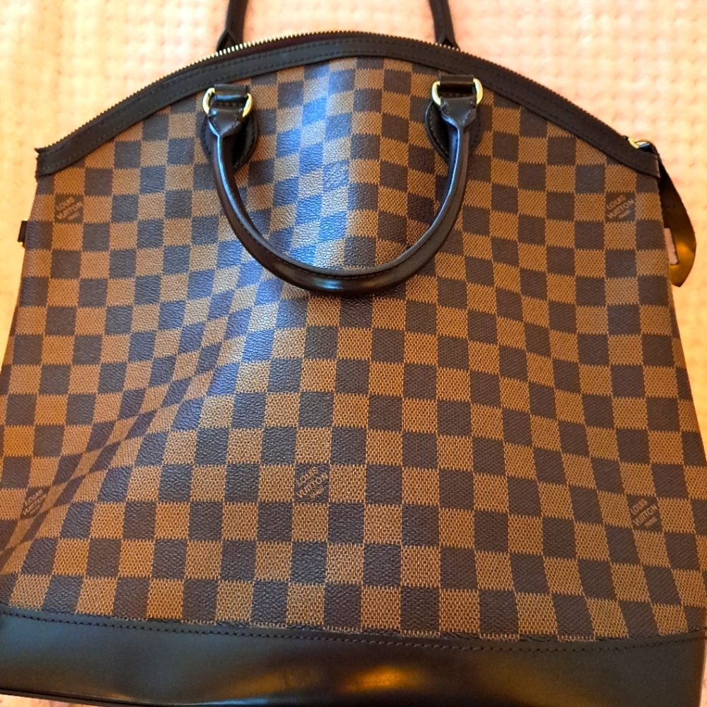 Louis Vutton tote with round handles.